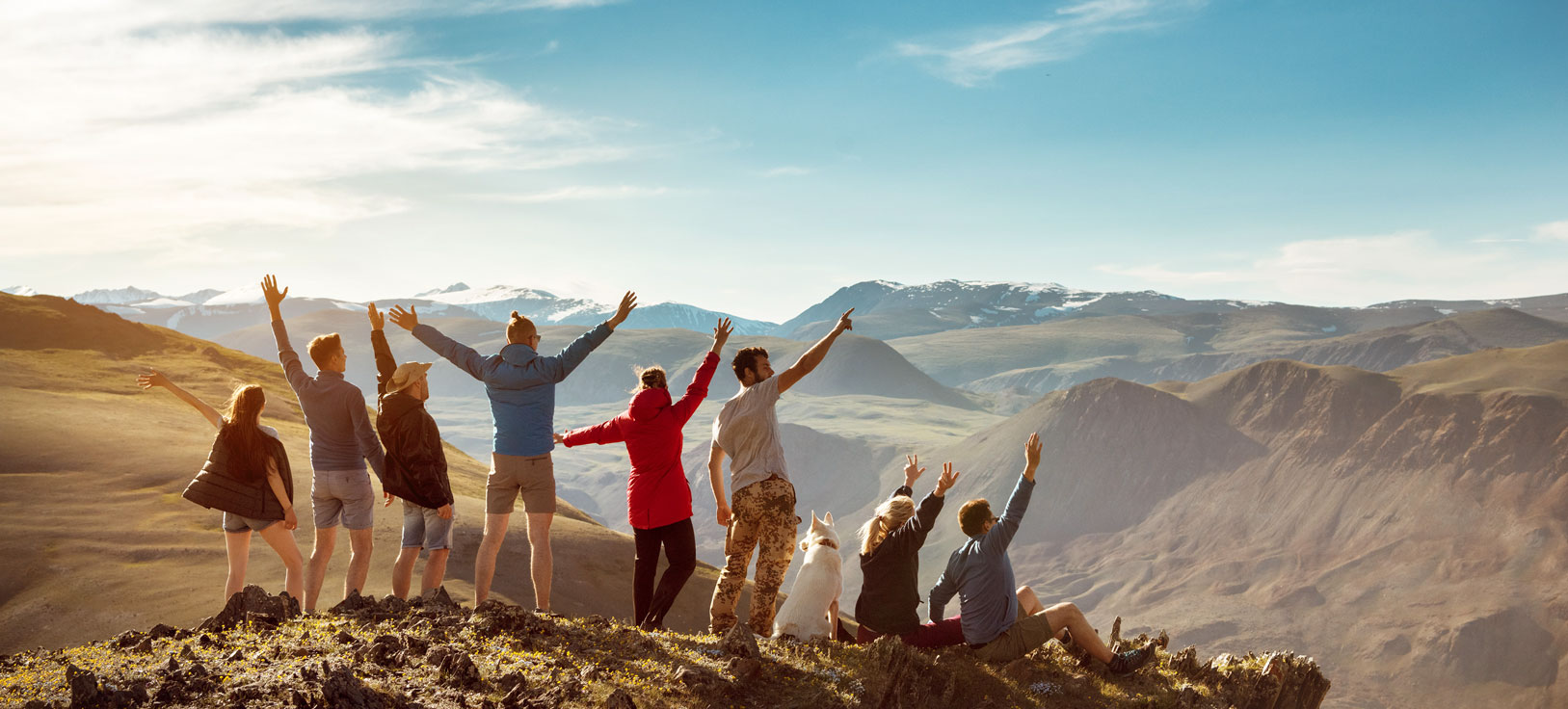 Group of people celebrate on mountain top